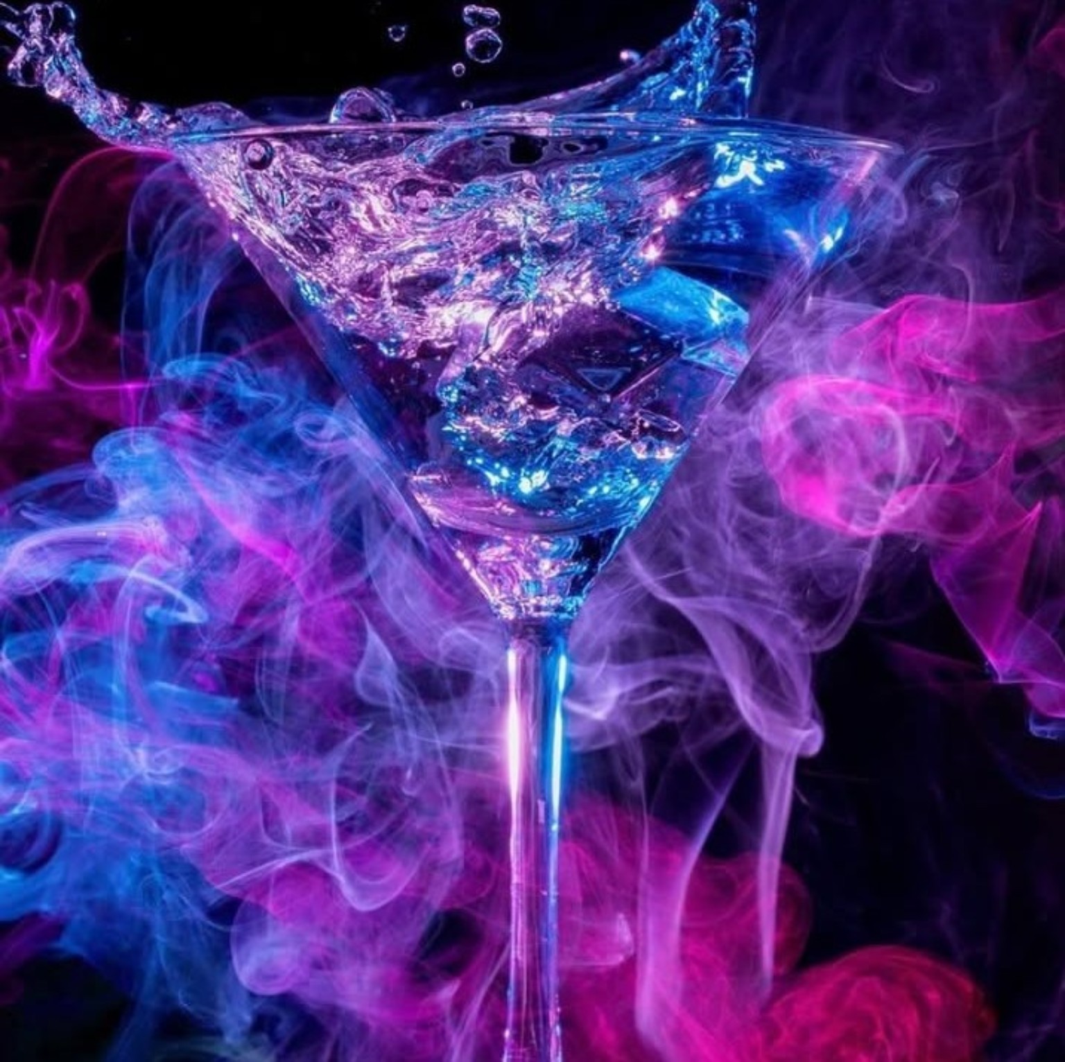 Martini glass lit in blue and pink with drifting smoke